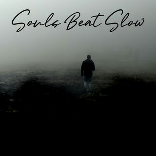 A foggy landscape with a silhouetted figure walking into the distance. Souls Beat Slow text in cursive.