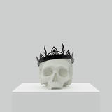 A skull wearing a silver crown